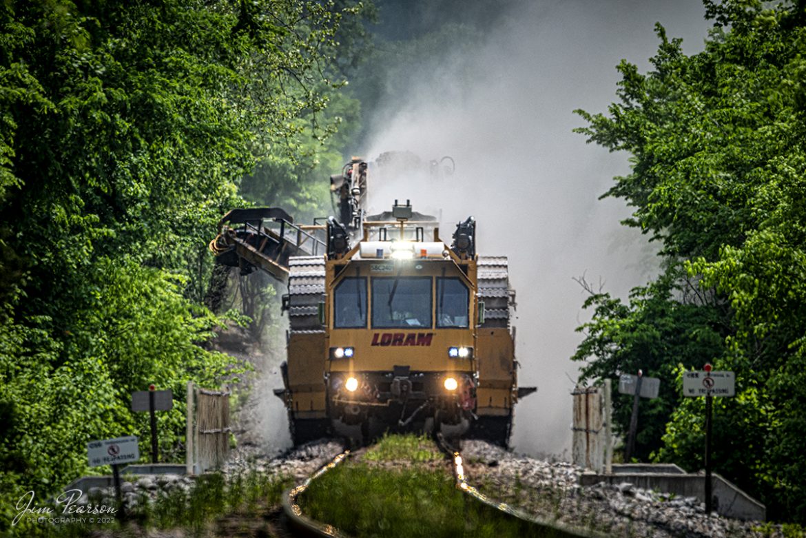 LoRam shoulder ballast cleaner SBC-2401 makes its way north on the CSX Henderson Subdivision out of Mortons Gap, Kentucky on May 11th, 2022, as it moves slowly along cleaning the ballast on both sides of the rails.

Shoulder ballast cleaning consists of removing ballast at the end of the ties, screening the ballast, and discarding fines and fouling material and restoring the good ballast to the shoulder. Integrated scarifiers break open end of tie mud pockets, removes fines, and restores ballast voids in the shoulders and under the tie ends and release damaging trapped water.

Tech Info: Nikon D800, RAW, Sigma 150-600 @ 600mm, f/6.3, 1/2000, ISO 500.

#trainphotography #railroadphotography #trains #railways #jimpearsonphotography #trainphotographer #railroadphotographer