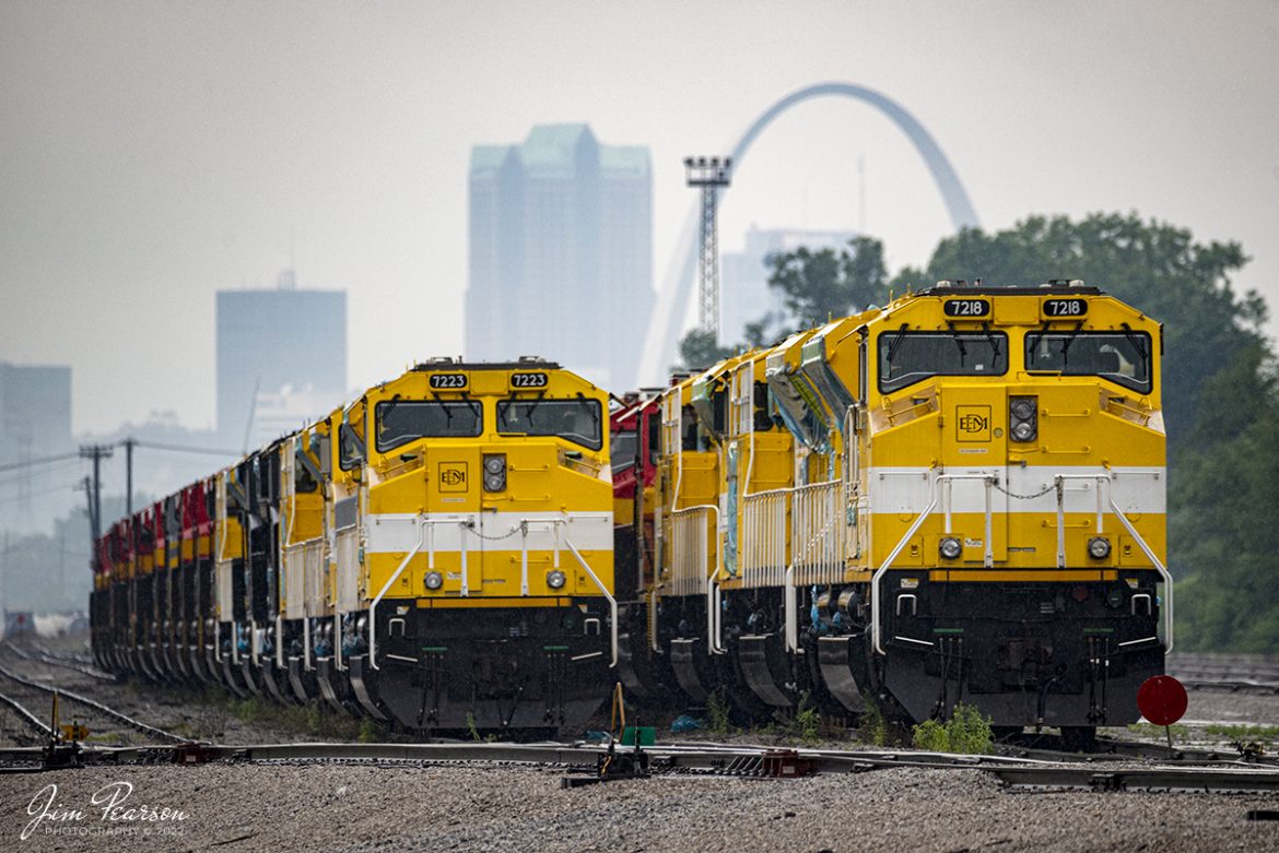 Progress Rail EMDs 7223 and 7218 head up strings of locomotives that are stored on the tracks at just outside the KCS East St. Louis, MO yard as downtown St. Louis and the Arch looms in the background a misty rainy day on May 21st, 2022.

According to Wikipedia: Progress Rail Services Corporation (reporting mark PRLX), a wholly owned subsidiary of Caterpillar since 2006, is a supplier of railroad and transit system products and services headquartered in Albertville, Alabama.  Founded as a recycling company in 1982, Progress Rail has increased the number of its product and service offerings over time to become one of the largest integrated and diversified suppliers of railroad and transit system products and services in North America. Progress Rail markets products and services worldwide and maintains 110 facilities in the United States, 34 in Mexico, four in Canada, two in Brazil, five in UK, one in Italy, and one in Germany.

Tech Info: Nikon D800, RAW, Sigma 150-600 @ 500mm, f/6, 1/500, ISO 500.

#trainphotography #railroadphotography #trains #railways #jimpearsonphotography #trainphotographer #railroadphotographer