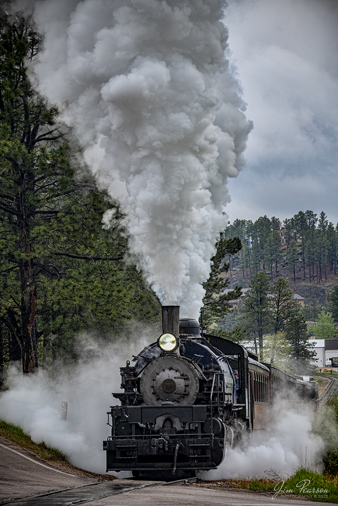The Black Hills Central Railway locomotive 108 climbs the grade as it approaches the Hill City - Keystone Road Crossing, as it makes its first trip of the day to Keystone, South Dakota from Hill City on May 30th, 2022! 

According to their website: Locomotive #108 joined its nearly identical twin, #110, at the beginning of the 2020 season following a four-year restoration. It is a 2-6-6-2T articulated tank engine that was built by the Baldwin Locomotives Works in 1926 for the Potlatch Lumber Company. It later made its way to Weyerhaeuser Timber Company and eventually to the Northwest Railway Museum in Snoqualmie, Washington.

The acquisition and subsequent restoration of locomotive #108 completed a more than 20-year goal of increasing passenger capacity which began with the restoration of #110 and the restoration of multiple passenger cars. Both large Mallet locomotives (pronounced Malley) can pull a full train of seven authentically restored passenger cars, up from the four cars utilized prior to their addition to the roster.

Tech Info: Nikon D800, RAW, Sigma 150-600mm @ 150mm, f/5, 1/400, ISO 320.

#trainphotography #railroadphotography #trains #railways #jimpearsonphotography #trainphotographer #railroadphotographer #blackhillscentralrailroad #STEAM #steamtrains