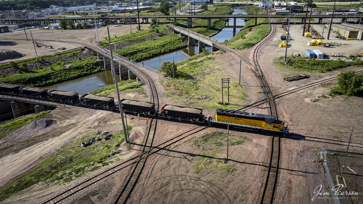 D&I Railroad 3020 (also nicknamed the Dakota and Iowa Railroad) heads across the Floyd River amid a maze of diamonds at Sioux City, Iowa on the Aberdeen Subdivision on June 3rd, 2022, with a loaded train.

According to Wikipedia: The D&I Railroad (DAIR) (also nicknamed the Dakota and Iowa Railroad) is a Class III shortline railroad which is a wholly owned subsidiary of L. G. Everist, Inc. The line hauls ethanol, dried distillers grains (DDG), corn oil, plastic pellets, cement, sand, gravel, and Sioux Quartzite, which is mined from two large quarries in Dell Rapids.

The D&I has a trackage rights agreement with BNSF that allows it to travel on three BNSF subdivisions to deliver and sell products, as they must use BNSFs system to reach their southern half of their trackage. The D&I operates on both former Chicago, Milwaukee, St. Paul and Pacific Railroad and Chicago and Northwestern Railroad trackage, which were handed over to the state of South Dakota in 1980-1981 after the Milwaukee Roads bankruptcy and subsequent abandonment of unprofitable lines.

Tech Info: DJI Mavic Air 2S Drone, RAW, 22mm, f/2.8, 1/1000, ISO 100.

#trainphotography #railroadphotography #trains #railways #dronephotography #trainphotographer #railroadphotographer #jimpearsonphotography