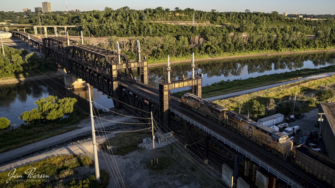 A Union Pacific loaded coal train heads across the bridge over the Kansas River towards Santa Fe Junction on the Kansas City Terminal Railroad (KCT) High Line at on June 29th, 2022.

The bridge is KCTs double deck, double track crossing of the Kansas River. The odd-looking silver towers on the bridge are lift mechanisms to raise the bridge in the event of flooding and are not connected most of the time. The upper deck line was primarily used by passenger trains from UP and Rock Island, moving to and from Kansas through the KC Union Station. Today primarily freight trains use this bridge.

Tech Info: DJI Mavic Air 2S Drone, RAW, 22mm, f/2.8, 1/640, ISO.

#trainphotography #railroadphotography #trains #railways #dronephotography #trainphotographer #railroadphotographer #jimpearsonphotography