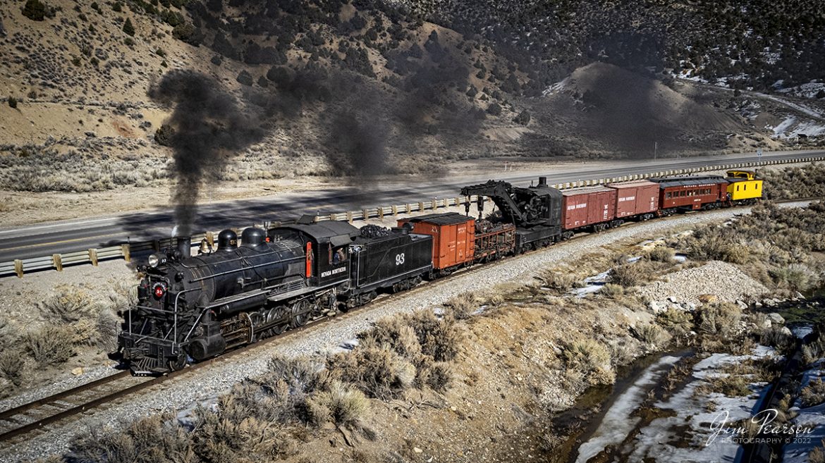 Ive been wanting to visit the Nevada Northern Railway for several years now and finally was able to do so during the Winter Steam Charter over the weekend of February 11-13th, 2022. I had a great trip and although drones werent allowed during the photo runbys, we chased by car on Sunday afternoon so we could grab some aerials as the train was moving between runby locations in Robinson Canyon. 


Here we see Nevada Northern Railway steam locomotive #91 pulling a work train southbound through the Canyon out of Ely, Nevada as the light begins to fall behind the mountains on February 13th, 2022.


According to Wikipedia: The Nevada Northern Railway Museum is a railroad museum and heritage railroad located in Ely, Nevada and operated by a historic foundation dedicated to the preservation of the Nevada Northern Railway.


The museum is situated at the East Ely Yards, which are part of the Nevada Northern Railway. The site is listed on the United States National Register of Historic Places as the Nevada Northern Railway East Ely Yards and Shops and is also known as the "Nevada Northern Railway Complex". The rail yards were designated a National Historic Landmark District on September 27, 2006. The site was cited as one of the best-preserved early 20th-century railroad yards in the nation, and a key component in the growth of the region's copper mining industry. Developed in the first decade of the 20th century, it served passengers and freight until 1983, when the Kennecott Copper Company, its then-owner, donated the yard to a local non-profit for preservation. The property came complete with all the company records of the Nevada Northern from its inception.

Engine #93 is a 2-8-0 that was built by the American Locomotive Company in January of 1909 at a cost of $17,610. It was the last steam locomotive to retire from original revenue service on the Nevada Northern Railway in 1961 and was restored to service in 1993.


Tech Info: DJI Mavic Air 2 Drone, RAW, 4.5mm (24mm equivalent lens) f/2.8, 1/2000, ISO 100.


#trainphotography #railroadphotography #trains #railways #jimpearsonphotography #trainphotographer #railroadphotographer