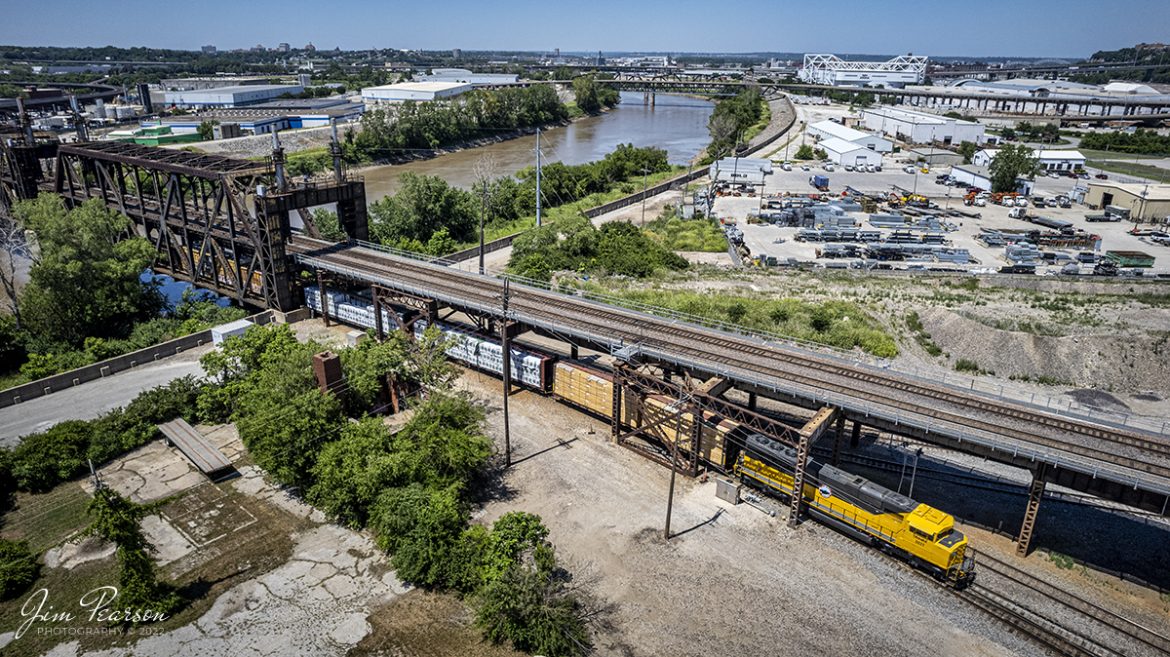 Kaw River Railroad lease unit WAMX 6033 slowly moves across the Kansas River into at Santa Fe Junction with a daily mixed freight on June 29th, 2022.

According to Wikipedia: The Kaw River Railroad (reporting mark KAW) is a Kansas City, Missouri railroad, established in June 2004. Twelve miles of original track served the Kansas City Southern Railroad and its customers in Kansas City and Union Station. The original KAW was a Kansas City Southern Railway Company property and was the first shortline Watco began operating for KCS, serving customers in the Greater Kansas City area and interchanges with the BNSF, KCS, and Union Pacific. 

The April 2005 expansion was a BNSF property serving customers in Clay County, Missouri and interchanges with the BNSF at Birmingham, Missouri. The KCTL interchanges with the BNSF, ICE, KCS, Norfolk Southern and Union Pacific at Kansas City.

Tech Info: DJI Mavic Air 2S Drone, RAW, 22mm, f/2.8, 1/2000, ISO 110.

#trainphotography #railroadphotography #trains #railways #dronephotography #trainphotographer #railroadphotographer #jimpearsonphotography