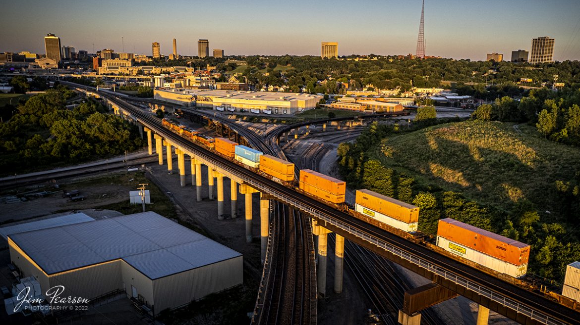 An eastbound BNSF Intermodal heads toward downtown Kansas City, Missouri on the Kansas Highline at Santa Fe Junction on June 29th, 2022 as the sun begins to cast long shadows and rich golden light from the sunset.

Tech Info: DJI Mavic Air 2S Drone, RAW, 22mm, f/2.8, 1/500, ISO 100.

#trainphotography #railroadphotography #trains #railways #dronephotography #trainphotographer #railroadphotographer #jimpearsonphotography