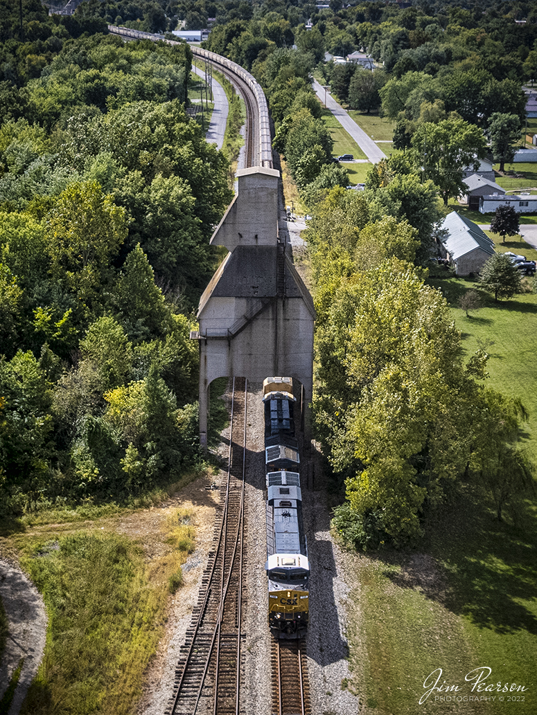 CSX empty grain train G026 passes under the old Louisville and Nashville Railway coaling tower at Sullivan, Indiana as it makes its way north on the first day of autumn along the CSX CE&D Subdivision on September 22, 2022. 

Tech Info: DJI Mavic Air 2S Drone, 22mm, f/2.8, 1/3000, ISO 100.

#trainphotography #railroadphotography #trains #railways #dronephotography #trainphotographer #railroadphotographer #jimpearsonphotography #csxce&dsubdivison