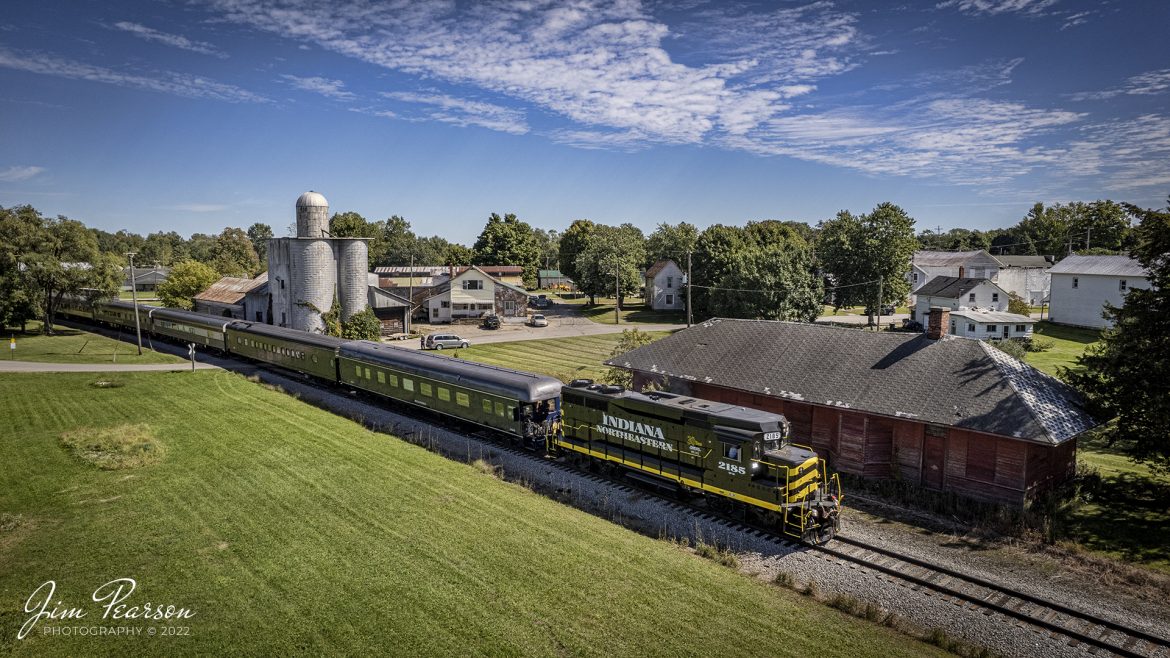 Indiana Northeastern Railroad 2185 leads the American History Train as it heads south at Montgomery, Michigan on September 23rd, 2022. The Nickel Plate Road steam locomotive 765 is on the end of the train around the curve and pulled the train northbound between Angola and Palmer Lake, Indiana, during the annual American History Days activities on September 24-25th of 2022

The train took guests back to the 1940s for a living history experience at Pleasant Lake from Angola. The passengers then got a 45-minute layover at Pleasant Lake where they visited with WWII reenactors, listened to live music and much more.

According to Wikipedia: The Indiana Northeastern Railroad (reporting mark IN) is a Class III short line freight railroad operating on nearly 130 miles (210 km) in southern lower Michigan, northeast Indiana and northwest Ohio. 

The Indiana Northeastern Railroad Company began operations in December 1992 and is an independent privately owned company. As of 2017 the railroad hauled more than 7,000 carloads per year. Commodities moved by the railroad include corn, soybeans, wheat, and flour. It also handles plastics, fiberboard, aluminum, copper, coal, perlite, stone, lumber, glass, rendering products, as well as agricultural fertilizers and chemicals. 

In the early 1990s the Hillsdale County Railway was heavily in debt. Its trackage was suffering from deferred maintenance and derailments were becoming a common occurrence. Then in 1992, a 50-car eastbound unit train from South Milford hauled by HCRC derailed near Hamilton, Indiana costing the South Milford Grain Company $30,000. The grain elevator company's owners decided to assume HCRC's $1 million in debt, and it acquired the railway. The grain company then created the Indiana Northeastern Railroad Company to take over the rail operations of the HCRC and its Pigeon River Railroad on December 22, 1992. It’s now owned by the grain company and farmers in the areas it serves, and major track improvements and upgrades have been done over the years creating a solid and reliable railroad.

Tech Info: DJI Mavic Air 2S Drone, RAW, 22mm, f/2.8, 1/2500, ISO 120.

#trainphotography #railroadphotography #trains #railways #dronephotography #trainphotographer #railroadphotographer #jimpearsonphotography #indianatrains