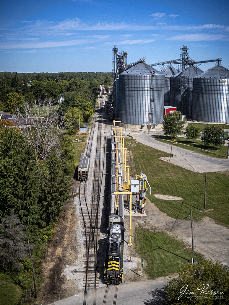 Indiana Northeastern Railroad 3084, along with another train work on picking up grain at Reading, Michigan on September 23rd, 2022.

According to Wikipedia: The Indiana Northeastern Railroad (reporting mark IN) is a Class III short line freight railroad operating on nearly 130 miles (210 km) in southern lower Michigan, northeast Indiana, and northwest Ohio. 

The Indiana Northeastern Railroad Company began operations in December 1992 and is an independent privately owned company. As of 2017 the railroad hauled more than 7,000 carloads per year. Commodities moved by the railroad include corn, soybeans, wheat, and flour. It also handles plastics, fiberboard, aluminum, copper, coal, perlite, stone, lumber, glass, rendering products, as well as agricultural fertilizers and chemicals. 

In the early 1990s the Hillsdale County Railway was heavily in debt. Its trackage was suffering from deferred maintenance and derailments were becoming a common occurrence. Then in 1992, a 50-car eastbound unit train from South Milford hauled by HCRC derailed near Hamilton, Indiana costing the South Milford Grain Company $30,000. The grain elevator company's owners decided to assume HCRC's $1 million in debt, and it acquired the railway. The grain company then created the Indiana Northeastern Railroad Company to take over the rail operations of the HCRC and its Pigeon River Railroad on December 22, 1992. It’s now owned by the grain company and farmers in the areas it serves, and major track improvements and upgrades have been done over the years creating a solid and reliable railroad.

Tech Info: DJI Mavic Air 2S Drone, RAW, 22mm, f/2.8, 1/3200, ISO 110.

#trainphotography #railroadphotography #trains #railways #dronephotography #trainphotographer #railroadphotographer #jimpearsonphotography #indianatrains #indiananortheasternrailroad