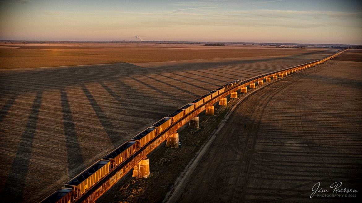 CSXT 845 leads E302heads down the viaduct at Rahm, Indiana as the rising sun casts long shadows across the landscape, on October 28th, 2022, as it heads north on the Henderson Subdivision. This train runs between Stilesboro, GA (Plant Bowen) and Sugar Camp Mine on the Evansville Western Railway.

Tech Info: DJI Mavic Air 2S Drone, RAW, 22mm, f/2.8, 1/730, ISO 100 -1.7stops.

#trainphotography #railroadphotography #trains #railways #dronephotography #trainphotographer #railroadphotographer #jimpearsonphotography