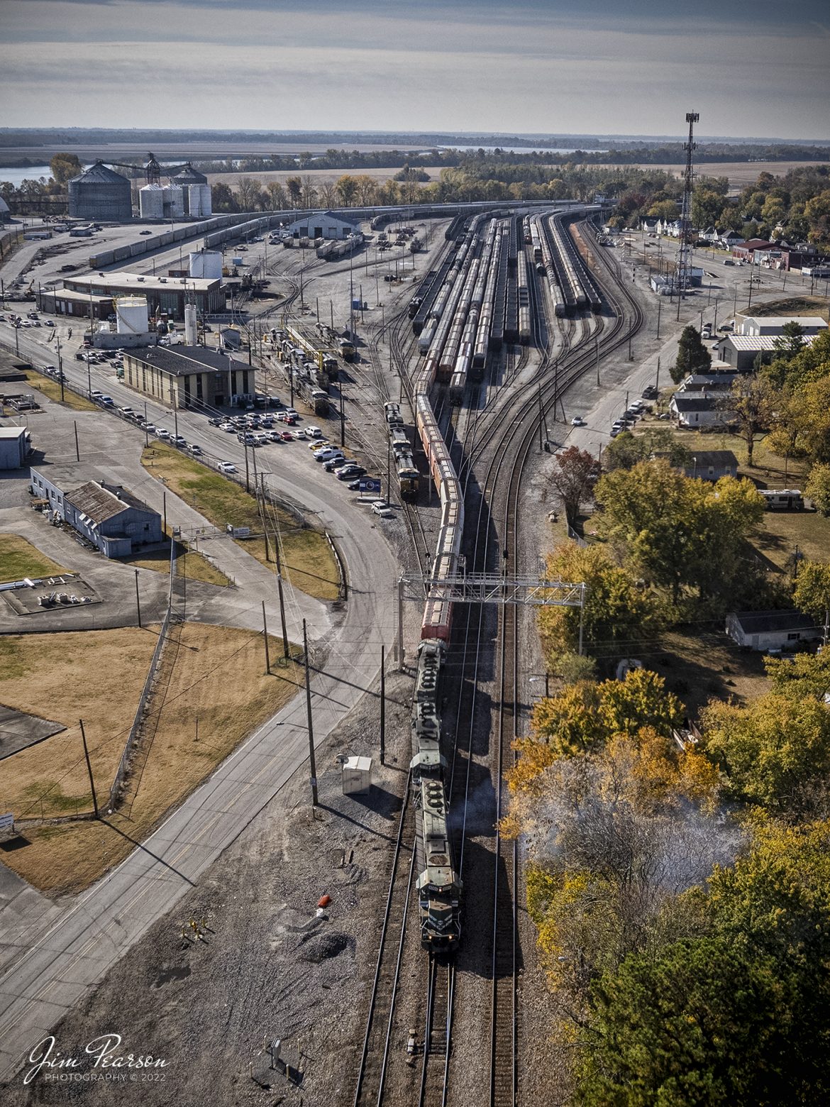 The daily Evansville Western Railway local, with EVWR 6004 (SD60) leading, backs their train into CSX Howell Yard in Evansville, IN, as it arrives to perform its interchange work, in this cropped aerial view from outside the yard area. Pretty much the entire Howell yard facility can be seen from this view looking south.

According to Wikipedia: The Evansville Western Railway (reporting mark EVWR) is a Class III common carrier shortline railroad operating in the southern Illinois and Indiana region. It is one of three regional railroad subsidiaries owned and operated by P&L Transportation.

Tech Info: DJI Mavic Air 2S Drone, 22mm, f/2.8, 1/3000, ISO 120.

#trainphotography #railroadphotography #trains #railways #dronephotography #trainphotographer #railroadphotographer #jimpearsonphotography #evansvillewesternrailway #evwr #indianatrains