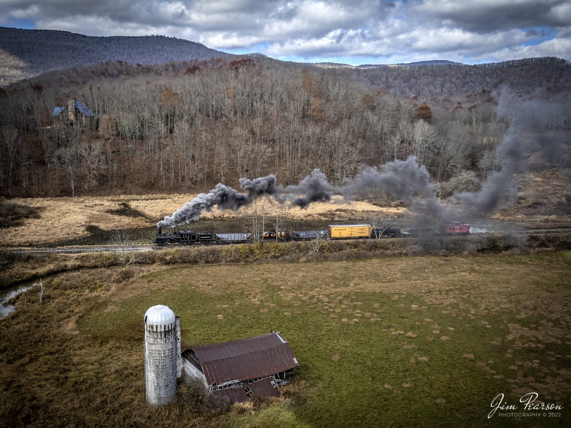 Meadow River Lumber Company steam locomotive, Heisler No. 6, leads a freight train past an old barn at Hosterman, West Virginia during the Mountain Rail WV, Rail Heritage Photography Weekend on November 4th, 2022. The event was held at the Durbin & Greenbrier Valley Railroad, Durbin, WV, and Cass Scenic Railroad, Cass, WV, from November 4-6th, 2022. 

According to Wikipedia: The Durbin and Greenbrier Valley Railroad (reporting mark DGVR) is a heritage and freight railroad in the U.S. states of Virginia and West Virginia. It operates the West Virginia State Rail Authority-owned Durbin Railroad and West Virginia Central Railroad (reporting mark WVC), as well as the Shenandoah Valley Railroad in Virginia.

Beginning in 2015, DGVR began operating the historic geared steam-powered Cass Scenic Railroad, which was previously operated by the West Virginia Division of Natural Resources as part of Cass Scenic Railroad State Park.

Tech Info: DJI Mavic Air 2S Drone, 22mm, f/2.8, 1/1000, ISO 200.

#trainphotography #railroadphotography #trains #railways #dronephotography #trainphotographer #railroadphotographer #jimpearsonphotography #cassscenicrailway #durbinandgreenbriervalleyrr #trainsfromtheair	#steamtrains
