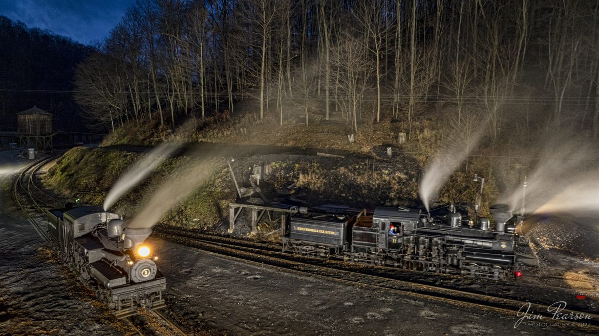 Cass Scenic Railway Shay locomotives 2, (C-80-3), and 11, (C-90-3) sit outside the engine house during the Rail Heritage Photography Weekend at Cass, West Virginia on the night of November 5th, 2022. 

According to Wikipedia: Cass Scenic Railroad, is an 11-mile (18 km) long heritage railway owned by the West Virginia State Rail Authority and operated by the Durbin and Greenbrier Valley Railroad. The park also includes the former company town of Cass and a portion of the summit of Bald Knob, highest point on Back Allegheny Mountain.

Founded in 1901 by the West Virginia Pulp and Paper Company (now WestRock), Cass was built as a company town to serve the needs of the men who worked in the nearby mountains cutting spruce and hemlock for the West Virginia Spruce Lumber Company, a subsidiary of WVP&P. At one time, the sawmill at Cass was the largest double-band sawmill in the world. It processed an estimated 1.25 billion board feet (104,000,000 cu ft; 2,950,000 m3) of lumber during its lifetime. In 1901 work started on the 4 ft 8+1⁄2 in (1,435 mm) standard gauge railroad, which climbs Back Allegheny Mountain. 

The railroad eventually reached a meadow area, now known as Whittaker Station, where a logging camp was established for the immigrants who were building the railroad. The railroad soon reached the top of Gobblers Knob, and then a location on top of the mountain known as 'Spruce'. The railroad built a small town at that location, complete with a company store, houses, a hotel, and a doctor's office. Work soon commenced on logging the red spruce trees, which grew in the higher elevations.

Tech Info: DJI Mavic Air 2S Drone, 22mm, f/2.8, 4sec exposure, -1.3 stops, ISO 100.

#trainphotography #railroadphotography #trains #railways #dronephotography #trainphotographer #railroadphotographer #jimpearsonphotography #cassscenicrailway #trainsfromtheair #steamtrains