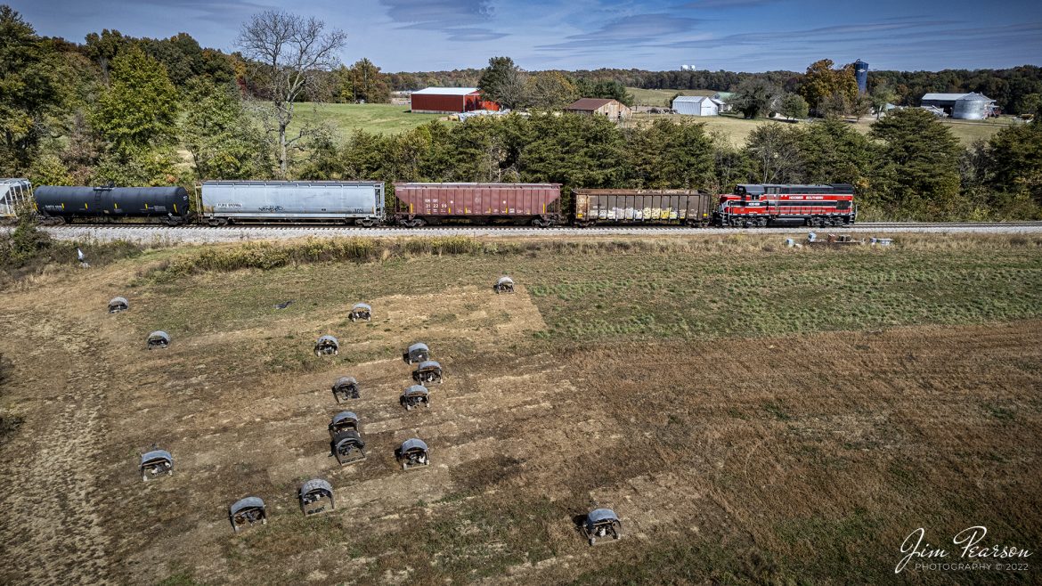 Hoosier Southern (HOS) 468 leads the daily local as through the countryside at Buffalo City, IN and heads to Tell City, IN, after picking up its interchange work from Norfolk Southern Railway at Lincoln City, IN on October 20th, 2022. The small structures are for a local farmers chicken, which I thought made an interesting addition to the photo.

The railroad originally consisted of a 22.3-mile line between the Indiana communities of Cannelton and Santa Claus that the Port Authority purchased from Norfolk Southern in 1991. The line had been unused since the mid-1980s and Norfolk Southern was considering abandonment prior to the Port Authority's (PCPA) purchase.

PCPA's goal in obtaining and putting the Hoosier Southern line back into service was (and is) to attract new industry to Perry County. When Waupaca Foundry announced plans to build a facility just north of Tell City in 1995, the Port Authority undertook construction of a spur to that site. In 1996, an additional 2.4 miles of trackage between Santa Claus and Lincoln City was added to the HOS system. This trackage was also purchased from Norfolk Southern.

Combined with the Tell City River Port on the Ohio River at Tell City, the Hoosier Southern provides multimodal transportation to serve the needs of businesses in both Perry and Spencer counties.

Though the Hoosier Southern is no longer part of the Norfolk Southern system, it interchanges with the NS system at Lincoln City. NS gives HOS customers a direct connection to much of the eastern United States, with lines to such centers of commerce as Kansas City, Missouri and Louisville, Kentucky.

Tech Info: DJI Mavic Air 2S Drone, RAW, 22mm, f/2.8, 1/2000, ISO 120.

#trainphotography #railroadphotography #trains #railways #dronephotography #trainphotographer #railroadphotographer #jimpearsonphotography #HoosierSouthernRailroad #indianarailroads #trainsfromtheair