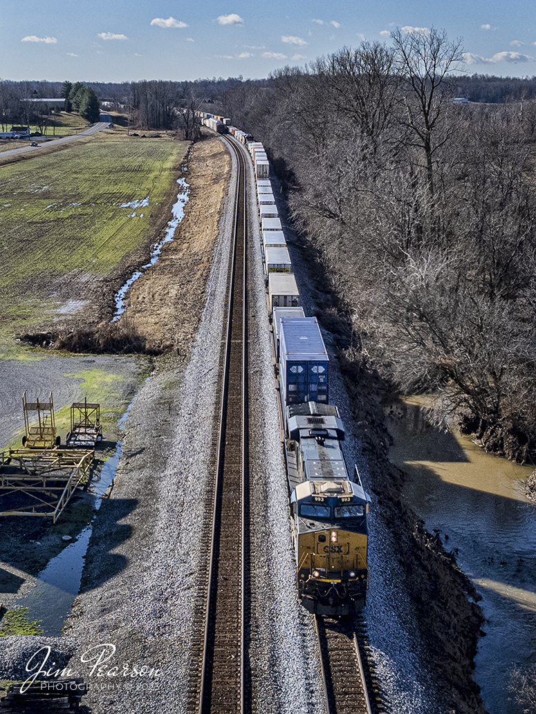 CSXT 993 heads up CSX intermodal I028 as it passes M513, in the siding, at the north end of Slaughters, Ky as it heads north on the Henderson Subdivision on January 4th, 2023.

Tech Info: DJI Mavic Air 2S Drone, 22mm, f/2.8, 1/2000, ISO 100.

#trainphotography #railroadphotography #trains #railways #dronephotography #trainphotographer #railroadphotographer #jimpearsonphotography #csxhendersonsubdivision #trainsfromtheair #kentuckytrains