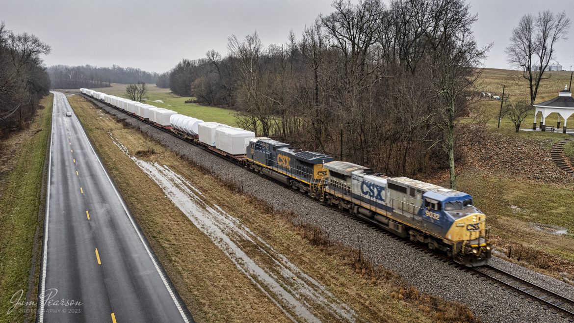 CSXT 9032 heads S988, with a load of windmill parts, heads north at Sebree, Kentucky, on January 24th, 2023, as they make their way north on the Henderson Subdivision, on a wet and dreary winter day.

Tech Info: DJI Mavic Air 2S Drone, RAW, 22mm, f/2.8, 1/80, ISO 140.

#trainphotography #railroadphotography #trains #railways #dronephotography #trainphotographer #railroadphotographer #jimpearsonphotography #trainsfromtheair #csxhendersonsubdivision #kentuckytrains