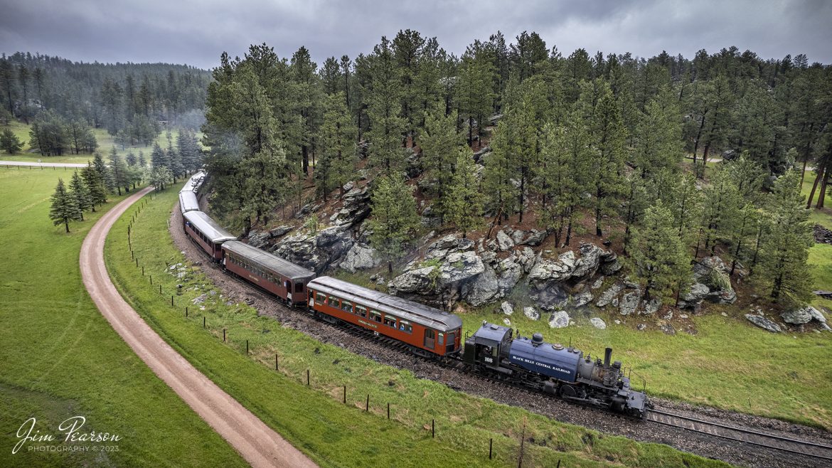 The 1880 Train, Black Hills Central Railroad locomotive crew on 108 rounds a curve as they head through the Black Hills on the way to Keystone, SD on May 30th, 2022, under stormy skies. 

According to their website: Locomotive #108 joined its nearly identical twin, #110, at the beginning of the 2020 season following a four-year restoration. It is a 2-6-6-2T articulated tank engine that was built by the Baldwin Locomotives Works in 1926 for the Potlatch Lumber Company. It later made its way to Weyerhaeuser Timber Company and eventually to the Northwest Railway Museum in Snoqualmie, Washington.

The acquisition and subsequent restoration of locomotive #108 completed a more than 20-year goal of increasing passenger capacity which began with the restoration of #110 and the restoration of multiple passenger cars. Both large Mallet locomotives (pronounced “Malley”) can pull a full train of seven authentically restored passenger cars, up from the four cars utilized prior to their addition to the roster.

Tech Info: DJI Mavic Air 2S Drone, RAW, 22mm, f/2.8, 1/500, ISO 110.

#trainphotography #railroadphotography #trains #railways #dronephotography #trainphotographer #railroadphotographer #jimpearsonphotography #blackhillsrailway #1880blackhillsrailway
