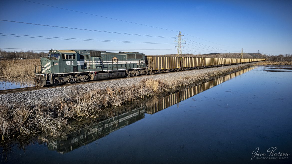 Paducah and Louisville 4512 brings up the DPU end of empty coal train WYX3 as it passes through a wetlands area on the way to pickup another load of coal at the Warrior Coal Mine loop outside of Nebo, Kentucky, as the train is reflected in the calm waters on February 13th, 2023.

Tech Info: DJI Mavic Air 2S Drone, 22mm, f/2.8, 1/1250, ISO 110.

#trainphotography #railroadphotography #trains #railways #dronephotography #trainphotographer #railroadphotographer #jimpearsonphotography #csx #trainsfromadrone #kentuckytrains #paducahandlouisvillerailway #coaltrain #PAL