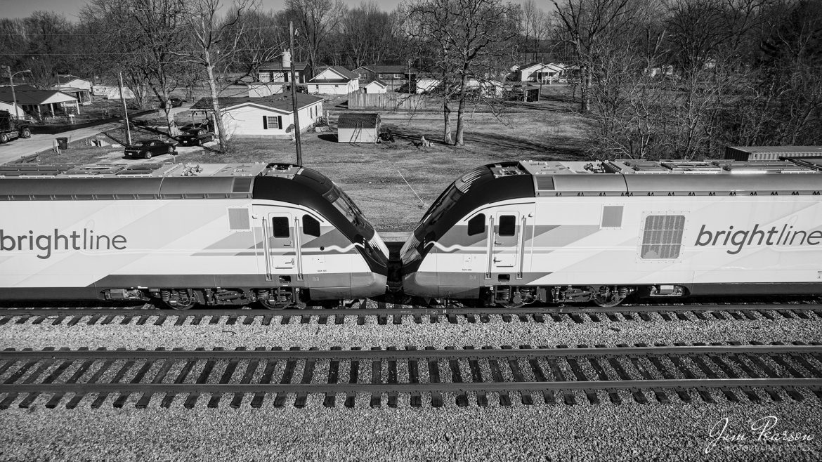 Two engines from Brightlines Orange 2 trainset sit nose to nose in the siding at Crofton, Kentucky on CSX S993 as it waits to continue its move south on the CSX Henderson subdivision, on February 13th, 2023, on its way to Orlando, Florida. 

According to the GoBrightline Facebook page, This completes our fleet of 10 train sets and is the final of the five new trains for our Orlando extension! We cant wait to welcome Bright Orange 2 to our Vehicle Maintenance Facility in Orlando. Safe travels, and see you soon, Bright Orange 2!

Tech Info: DJI Mavic Air 2S Drone, 22mm, f/2.8, 1/4000, ISO 200.

#trainphotography #railroadphotography #trains #railways #dronephotography #trainphotographer #railroadphotographer #jimpearsonphotography #csx #trainsfromadrone #kentuckytrains #brightlinetrain #csxhendersonsubdivision