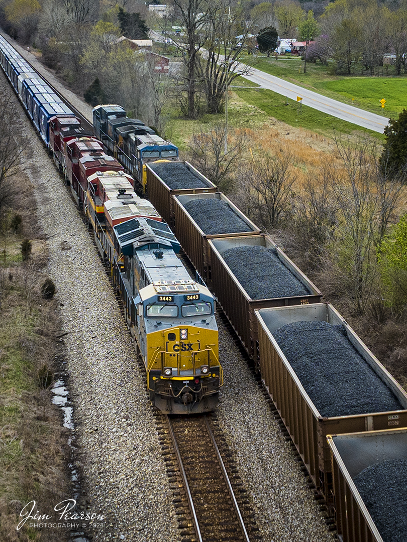 CSX B244, an empty potash train waits in the siding at the north end of Kelly, Kentucky on the CSX Henderson Subdivision, on March 31st, 2023, as loaded coal train passes him on the main headed south. CSX B244 is a fairly new, as-needed potash train off the CP that runs between Chicago, IL and Tampa, FL. The power on this move is CSX 3443, KCS 4728, CP 8933 and CP 8021.

Tech Info: DJI Mavic 3 Classic Drone, RAW, 24mm, f/2.8, 1/1000, ISO 140.

#trainphotography #railroadphotography #trains #railways #dronephotography #trainphotographer #railroadphotographer #jimpearsonphotography #kentuckytrains #csx #csxrailway #KellyKy #mavic3classic #drones #trainsfromtheair #trainsfromadrone #csxhendersonsubdivison