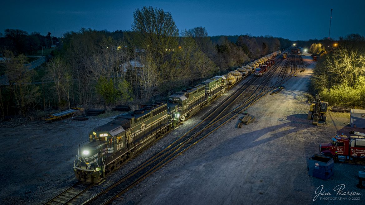Paducah and Louisville 3811, 2121 and 2100 head up a southbound military train loaded with armor from Ft. Knox, Ky, at West Yard in Madisonville, Ky as the last light of the day fades on April 4th, 2023. A new crew onboard prepares their train for departing for Paducah, Ky where Im told the equipment will be picked up by BNSF or CN to continue its move.

In the yard you can see a lot of RJ Corman equipment where they have been working on redoing the yard tracks for the past week or so.

Tech Info: DJI Mavic 3 Classic Drone, RAW, 24mm, f/2.8, 1 second, ISO 210.

#trainphotography #railroadphotography #trains #railways #dronephotography #trainphotographer #railroadphotographer #jimpearsonphotography #kentuckytrains #csx #csxrailway #MadisonvilleKy #mavic3classic #drones #trainsfromtheair #trainsfromadrone #PaducahandLouisvilleRailway, PALrailway #militarytrain