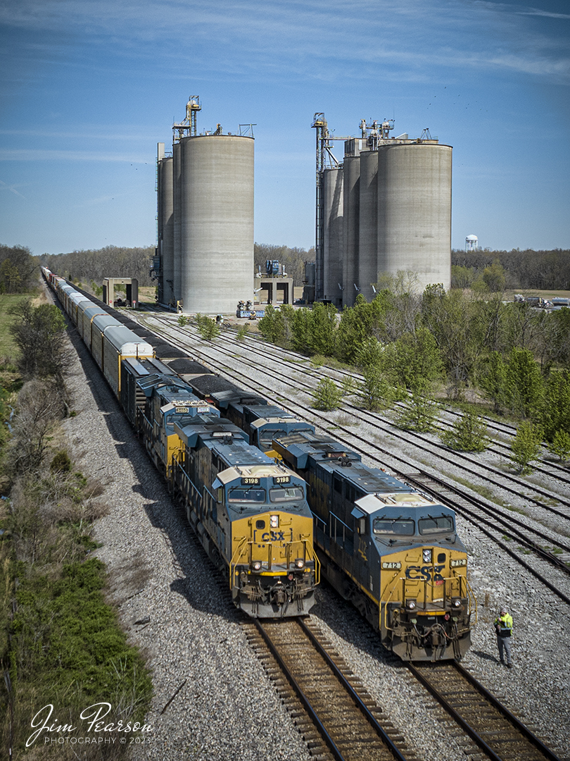 Hot intermodal CSX I025 passes a loaded coal train at Sebree, Kentucky as the coal trains conductor performs a roll-by inspection of the intermodal on April 8th, 2023, as they pass the Tyson Foods Grain facility. This intermodal runs with autoracks loaded with Teslas, bound for Florida.

Tech Info: DJI Mavic 3 Classic Drone, RAW, 24mm, f/2.8, 1/2000 sec, ISO 100.

#trainphotography #railroadphotography #trains #railways #dronephotography #trainphotographer #railroadphotographer #jimpearsonphotography #kentuckytrains #csx #csxrailway #mavic3classic #drones #trainsfromtheair #trainsfromadrone #Intermodal #coaltrain #SebreeKy