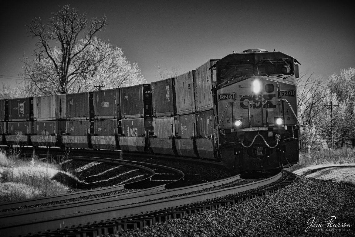 Infrared photo CSX I028 as it rounds the banked curve at the north end of Kelly, Ky as they head north on the Henderson Subdivision on April 12th, 2023. I028 is one of 4 hot intermodals that travel up and down the Henderson Subdivision and this on travels between Fairburn, GA and Bedford Park, IL.

Tech Info: Fuji XT1 converted to 720nm, Nikon 18-250 @ 129mm, f/5.6, 1/500, ISO 400, +.7 Exposure Comp.

#trainphotography #railroadphotography #trains #railways #jimpearsonphotography #trainphotographer #railroadphotographer # infraredtrains #infraredphotography #csx