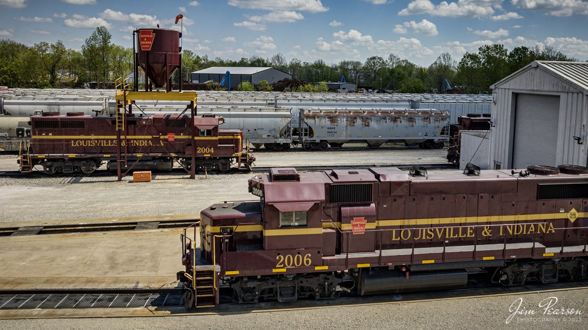 Louisville and Indiana Railroad locomotives 2004 and 2006 sit, tied down in their yard at Jeffersonville, Indiana, on Saturday, April 15th, 2023, as the railroad wasnt working on the day of my recent visit here. 

According to Wikipedia: The Louisville and Indiana Railroad is a Class III railroad that operates freight service between Indianapolis, Indiana and Louisville, Kentucky, with a major yard and maintenance shop in Jeffersonville, Indiana. It is owned by Anacostia Rail Holdings. The 106-mile line was purchased from Conrail in March 1994.

Tech Info: DJI Mavic 3 Classic Drone, RAW, 24mm, f/2.8, 1/2000 sec, ISO 110.

#trainphotography #railroadphotography #trains #railways #dronephotography #trainphotographer #railroadphotographer #jimpearsonphotography #kentuckytrains #csx #csxrailway #mavic3classic #drones #trainsfromtheair #trainsfromadrone #LandIRailway, #Jeffersonville, #IndianaTrains, #louisvilleandindianarailroad