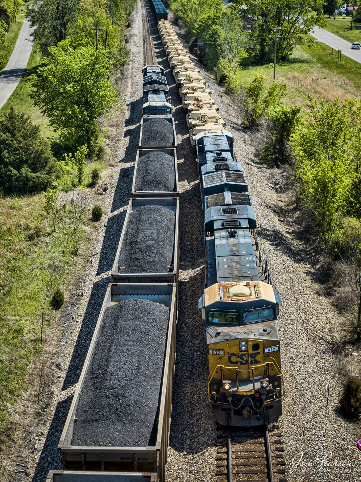 CSX M512 waits on the main with 8 flats of M1 Tanks as loaded coal train C904 takes the siding at the north end of Kelly, Ky so they can pass each other on April 25th, 2023. M512 was too long at 13,000 plus feet to fit into the siding so they had to wait on the C904 to clear the north end of the siding, before continuing their move on the Henderson Subdivision.

Tech Info: DJI Mavic 3 Classic Drone, RAW, 24mm, f/2.8, 1/1600, ISO 130.

#trainphotography #railroadphotography #trains #railways #dronephotography #trainphotographer #railroadphotographer #jimpearsonphotography #kentuckytrains #KellyKy #mavic3classic #drones #trainsfromtheair #trainsfromadrone #csxhendersonsubdivision #kellyky #militarytrainmove