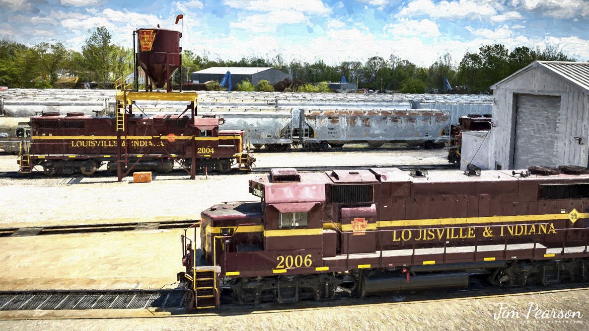 Digital Photo Art - Louisville and Indiana Railroad locomotives 2004 and 2006 sit, tied down in their yard at Jeffersonville, Indiana, on Saturday, April 15th, 2023, as the railroad wasnt working on the day of my recent visit here. 

According to Wikipedia: The Louisville and Indiana Railroad is a Class III railroad that operates freight service between Indianapolis, Indiana and Louisville, Kentucky, with a major yard and maintenance shop in Jeffersonville, Indiana. It is owned by Anacostia Rail Holdings. The 106-mile line was purchased from Conrail in March 1994.

Tech Info: DJI Mavic 3 Classic Drone, RAW, 24mm, f/2.8, 1/2000 sec, ISO 110.

#trainphotography #railroadphotography #trains #railways #dronephotography #trainphotographer #railroadphotographer #jimpearsonphotography #kentuckytrains #csx #csxrailway #mavic3classic #drones #trainsfromtheair #trainsfromadrone #LandIRailway, #Jeffersonville, #IndianaTrains, #louisvilleandindianarailroad