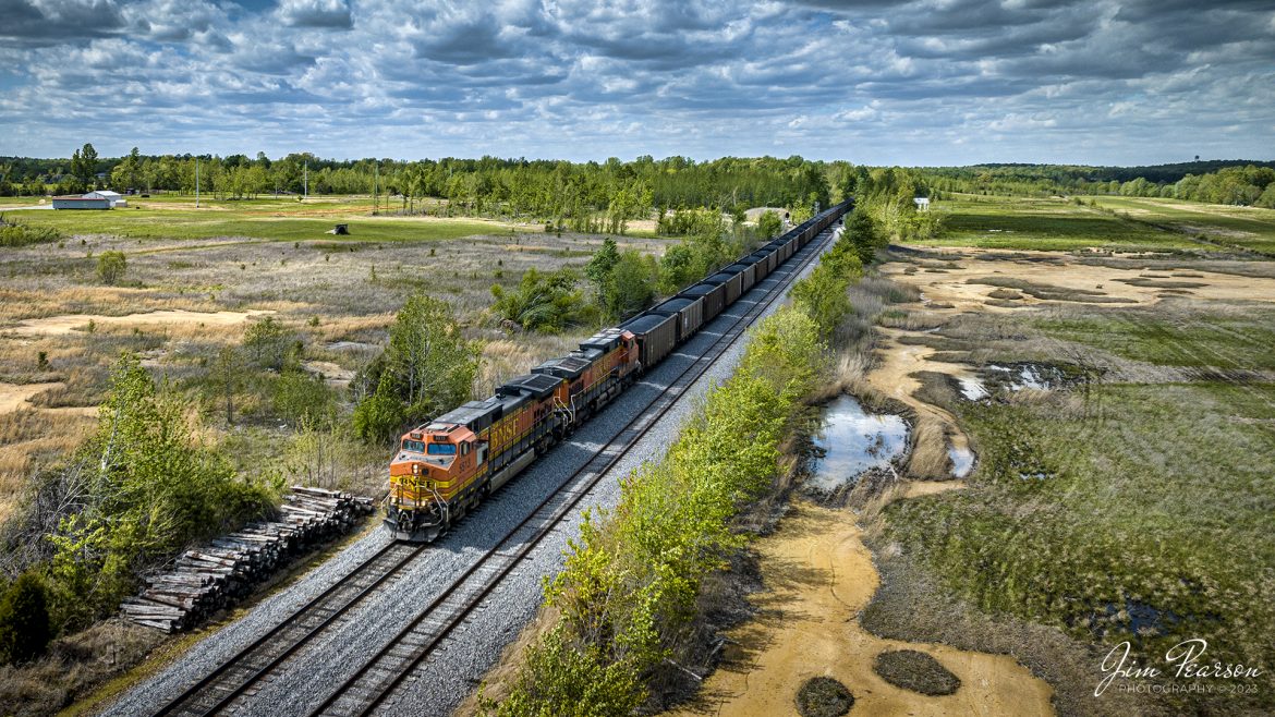 A loaded BNSF loaded coal train passes the siding at Dawson Springs, Kentucky as it heads south on the Paducah and Louisville Railway from Warrior coal mine loop at Madisonville, Ky on May 1st, 2023.

Tech Info: DJI Mavic 3 Classic Drone, RAW, 24mm, f/2.8, 1/2500, ISO 130.

#trainphotography #railroadphotography #trains #railways #dronephotography #trainphotographer #railroadphotographer #jimpearsonphotography #BNSFtrains #mavic3classic #drones #trainsfromtheair #trainsfromadrone #coaltrain #BNSF #Dawsonspringsky