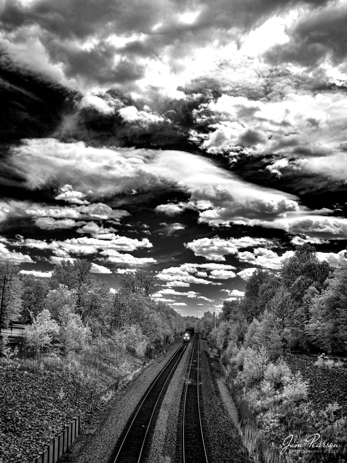 This week's Saturday Infrared photo is of CSX M512 headed north at Nortonville, Ky on the CSX Henderson Subdivision on May 2nd, 2023. This train runs daily between Radnor Yard in Nashville, TN and Avon, IN and normally works at Works Casky yard at Hopkinsville, KY, Howell Yard in Evansville, IN, and Princeton, IN. Its daily counterpart is M513.

Tech Info: Fuji XT-1, RAW, Converted to 720nm B&W IR, Nikon 10-24mm @18mm, f/6.3, 1/250, ISO 200.

#trainphotography #railroadphotography #trains #railways #jimpearsonphotography #infraredtrainphotography #infraredphotography #trainphotographer #railroadphotographer #csxrailroad #csxhendersonsubdivision