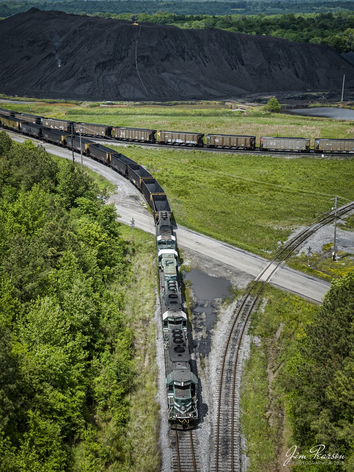 A string of Paducah and Louisville locomotives, with one Evansville Western Railway unit, pulls a long string of empty coal cars out of the loop at the Calvert City Terminal as they prepare to head south to Paducah, Kentucky on May 8th, 2023.

Tech Info: DJI Mavic 3 Classic Drone, RAW, 24mm, f/2.8, 1/1250, ISO 100.

#trainphotography #railroadphotography #trains #railways #dronephotography #trainphotographer #railroadphotographer #jimpearsonphotography #PALtrains #mavic3classic #drones #trainsfromtheair #trainsfromadrone #pal #CCT #emptycoaltrain #calvertcityterminal #kentuckytrains #CalvertCityKy