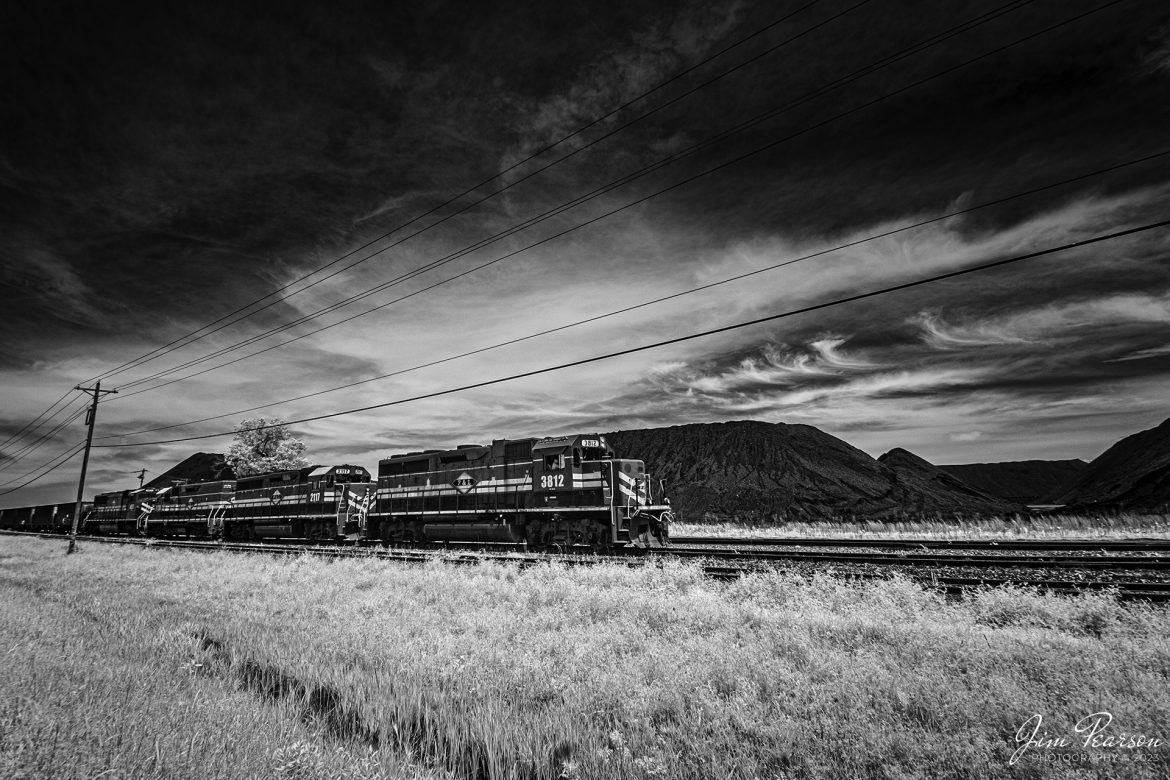 This week's Saturday Infrared photo is of Paducah and Louisville 3812 leading a lash-up of power as they head out of the coal loop at Calvert City Terminal, after dropping off a load of coal on May 8th, 2023.
According to Wikipedia: The Paducah & Louisville Railway is a Class II railroad that operates freight service between Paducah and Louisville, Kentucky. The line is located entirely within the Commonwealth of Kentucky. The 270-mile line was purchased from Illinois Central Gulf Railroad in August 1986.

Tech Info: Fuji XT-1, RAW, Converted to 720nm B&W IR, Nikon 10-24mm @10mm, f/5.6, 1/250, ISO 200.

#trainphotography #railroadphotography #trains #railways #jimpearsonphotography #infraredtrainphotography #infraredphotography #trainphotographer #railroadphotographer #paducahandlouisvillerailway #pal #shortlinerailroads #regionalrailroads