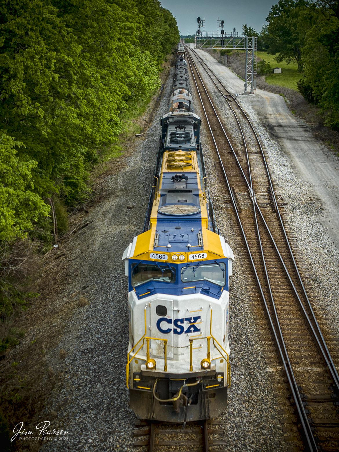 After just finishing setting out a bad order car at Casky, CSXT 50th Anniversary of Operation Lifesaver locomotive 4568 leads G412, as it pulls north from Casky Yard at Hopkinsville, Kentucky on May 10th, 2023, on the Henderson Subdivision.

Tech Info: DJI Mavic 3 Classic Drone, RAW, 24mm, f/2.8, 1/1000, ISO 130.

#trainphotography #railroadphotography #trains #railways #dronephotography #trainphotographer #railroadphotographer #jimpearsonphotography #mavic3classic #drones #trainsfromtheair #trainsfromadrone #coaltrain #CSXT #HopkinsvilleKy #CSXOperationLifesaver #CSXHendersonSubdivision