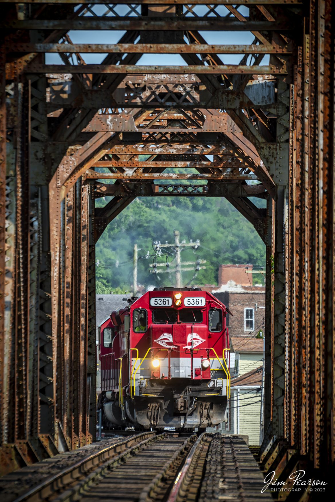 RJ Corman 5361 leads a train loaded with aluminum ingots as they pull onto the bridge over the Kentucky River at Frankfort, Ky on the CSX LCL Subdivision on May 18th, 2023. This train is also referred to as the ALCAN train and it runs daily between Louisville and Berea, Ky, to and from the Novelis Recycling center at Berea. Alcan used to own the Company and the name most folks use for this train is still Alcan even though Novelis bought them out. 

The Berea plant is one of the worlds largest plants dedicated to aluminum can recycling, and they process approximately 20 percent of the United States used aluminum cans, by melting them down and producing sheet ingots, according to the Novelis website.

Tech Info: Nikon D800, RAW, Nikon 70-300 @ 260mm, f/5.6, 1/250, ISO 110.

#trainphotography #railroadphotography #trains #railways #dronephotography #trainphotographer #railroadphotographer #jimpearsonphotography #CSXtrains #NikonD800 #RJCtrain #RJCorman