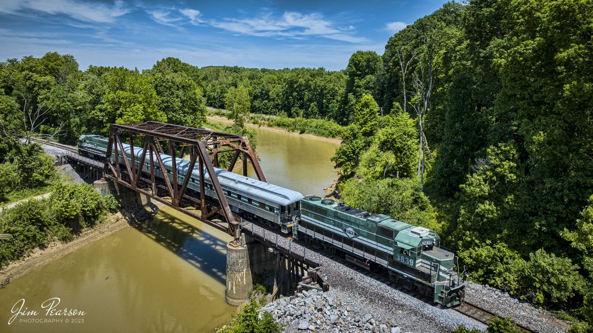 Evansville Western Railway (EVWR) 3839 leads EVWR3 south to Mount Vernon, Indiana across the bridge over Big Creek at Black Township, Indiana with an Operation Lifesaver train, with local officials, fire and police department chiefs and other officials, on May 22nd, 2023. The business cars are from the Paducah and Louisville Railway, which owns the EVWR.

The Evansville Western Railway is a Class III common carrier shortline railroad operating in the southern Illinois and Indiana region. It is one of three regional railroad subsidiaries owned and operated by P&L Transportation. The other company is the Appalachian and Ohio Railroad, located in West Virginia.

Tech Info: DJI Mavic 3 Classic Drone, RAW, 24mm, f/2.8, 1/1600, ISO 130.

#trainphotography #railroadphotography #trains #railways #dronephotography #trainphotographer #railroadphotographer #jimpearsonphotography #CSXtrains #mavic3classic #drones #trainsfromtheair #trainsfromadrone #EVWR #evansvillewesternrailway #trainsfromtheair