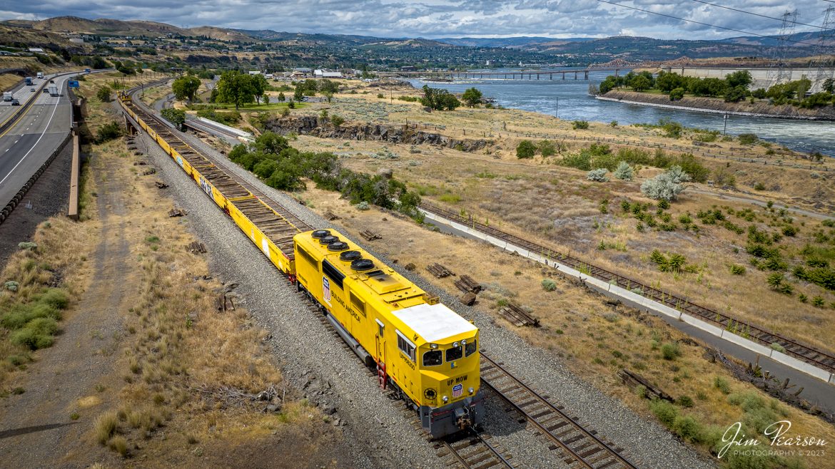 During our run to Seattle, Washington my sister and I traveled along the Columbia River Gorge on our recent trip and the only Union Pacific train I caught on this day was this Maintenance of Way train at The Dalles in Oregon. It was busy picking up ties on the Portland Subdivision,down from The Dalles Dam, on June 20th, 2023, with UP 958200 leading the trainset. 

At the far end of the train, you can see where they are picking up ties along the right-of-way and Ill be posting another shot showing that end tomorrow morning. An unusual and cool looking piece of equipment for sure!

From what I can find online Union Pacific took delivery of the RELCO built MofW work train set #958200 in July 2019. The set is made up of special flats/gons and a rebuilt SD-40-2 locomotive (former number unknown). The trailing unit was numbered UP 958201.

Tech Info: DJI Mavic 3 Classic Drone, RAW, 24mm, f/2.8, 1/1600, ISO 100.

#trainphotography #railroadphotography #trains #railways #dronephotography #trainphotographer #railroadphotographer #jimpearsonphotography #trains #mavic3classic #drones #trainsfromtheair #trainsfromadrone #UnionPacific #MOWtrainset #oregontrains