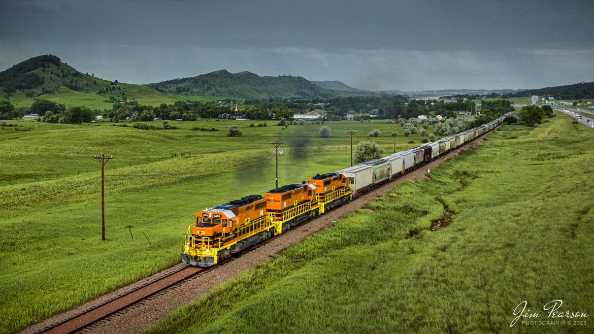 Rapid City, Pierre, and Eastern Railroad locomotives 3433, 3469 and 3454 lead a northbound at Piedmont, South Dakota on the Black Hills Subdivision, as the rain cooperated by slacking off long enough for me to grab a few aerial shots of the trains move, on June 28th, 2023.

According to Wikipedia: Rapid City, Pierre & Eastern Railroad is a Class II freight railroad operating across South Dakota and southern Minnesota in the northern plains of the United States. Portions of the railroad also extend into Wyoming and Nebraska. It is owned and operated by Genesee & Wyoming.

Tech Info: DJI Mavic 3 Classic Drone, RAW, 24mm, f/2.8, 1/320, ISO 100.

#trainphotography #railroadphotography #trains #railways #dronephotography #trainphotographer #railroadphotographer #jimpearsonphotography #trains #RCPE #mavic3classic #drones #trainsfromtheair #trainsfromadrone #SouthDakotaTrains #shortlinerailroad #regionalrailroad