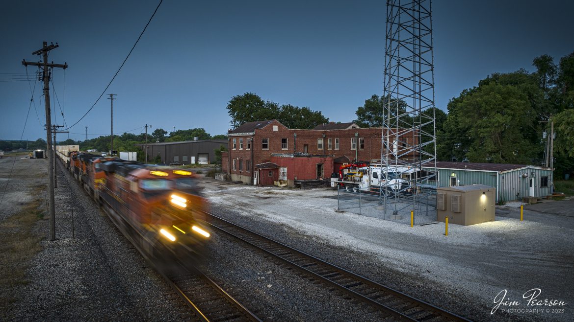 A westbound BNSF intermodal passes the old depot at Chillicothe, Illinois as the light of day begins to fade on the Chillicothe Subdivision on June 30th, 2023.

According to Wikipedia: Chillicothe was an Amtrak stop in Chillicothe, Illinois; a suburb of Peoria. The station was a stop on the Southwest Chief between Chicago Union Station and Los Angeles Union Station before the alignment was changed to go via Burlington Northern Santa Fe's Mendota Subdivision in 1996.

Amtrak service at Chillicothe began on May 1, 1971, with the Chicago-Houston Texas Chief, a service previously run by the Atchison, Topeka and Santa Fe Railway. This route was renamed the Lone Star in 1974 and discontinued in 1979.

For most of Amtrak's first quarter-century, it was Peoria's only link to the national rail system. The short-lived Prairie Marksman ran to East Peoria in 1980 and 1981.

Tech Info: DJI Mavic 3 Classic Drone, RAW, 24mm, f/2.8, 1/15, ISO 120.

#trainphotography #railroadphotography #trains #railways #dronephotography #trainphotographer #railroadphotographer #jimpearsonphotography #trains #mavic3classic #drones #trainsfromtheair #trainsfromadrone #IllinoisTrains #BNSF
