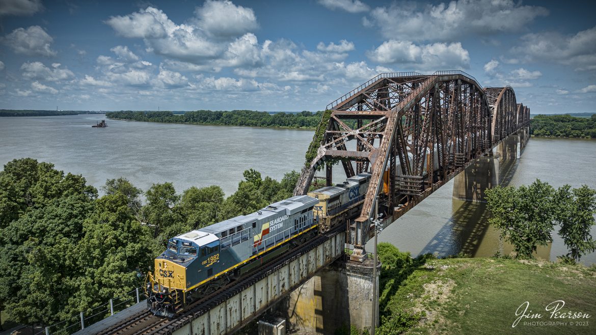 Today we were fortunate on the Henderson Subdivision to have the new CSX Heritage series the Seaboard System locomotive unit 1982, lead on CSX I025 after going north on I026 on 4th of July. Today I caught it as it made its way across the Ohio River Bridge between Rahm, Indiana into Henderson, Ky, on July 6th, 2023.

According to Wikipedia: The Seaboard System Railroad, Inc. (reporting mark SBD) was a US Class I railroad that operated from 1982 to 1986.

Since the late 1960s, Seaboard Coast Line Industries had operated the Seaboard Coast Line and its sister railroadsnotably the Louisville & Nashville and Clinchfieldas the "Family Lines System". In 1980, SCLI merged with the Chessie System to create the holding company CSX Corporation; two years later, CSX merged the Family Lines railroads to create the Seaboard System Railroad.

In 1986, Seaboard renamed itself CSX Transportation, which absorbed the Chessie System's two major railroads the following year.

Tech Info: DJI Mavic 3 Classic Drone, RAW, 24mm, f/2.8, 1/1600, ISO 100.

#trainphotography #railroadphotography #trains #railways #dronephotography #trainphotographer #railroadphotographer #jimpearsonphotography #trains #csxt #mavic3classic #drones #trainsfromtheair #trainsfromadrone #CSXHeritageUnits