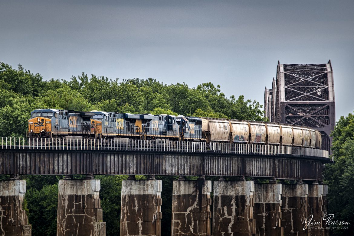 CSX empty grain train G412 with CSXT 592, 5243, 5383 and 6476 leading, heads down the viaduct at Rahm, Indiana after crossing the Ohio River from Henderson, Kentucky on July 17th, 2023, on the Henderson Subdivision.

Tech Info: Nikon D800, RAW, Sigma 150-600 @ 440mm, f/5.6, 1/200, ISO 250.

#trainphotography #railroadphotography #trains #railways #jimpearsonphotography #trainphotographer #railroadphotographer #CSXT #CSXHendersonSubdivision #kentuckytrains #indianatrains