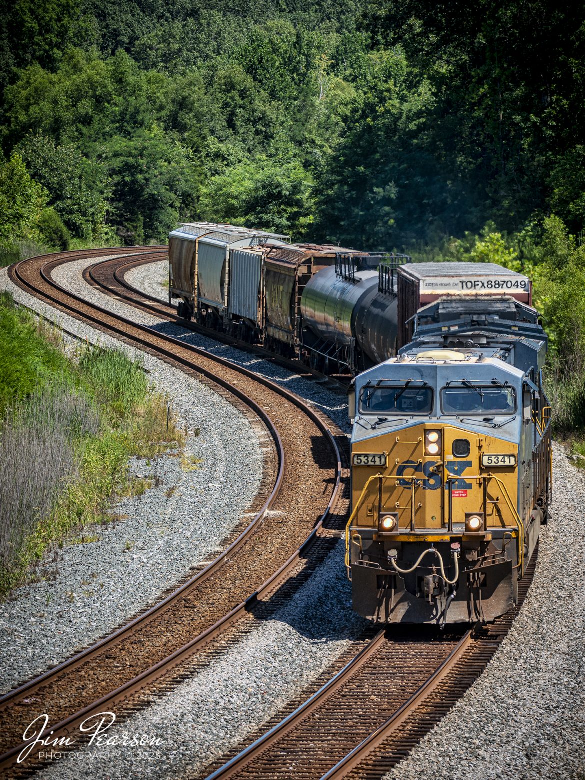 CSXT 5341 local, L391, makes their way through the S curve with its short train, as they make their way south at Nortonville, Kentucky on the Henderson Subdivision. This train runs daily between Casky Yard in Hopkinsville, Ky and Atkison Yard at Madisonville, Ky.

Tech Info: Nikon D800, Sigma 150-600 @150mm, f/5, 1/1000, ISO 280.

#trainphotography #railroadphotography #trains #railways #dronephotography #trainphotographer #railroadphotographer #jimpearsonphotography
