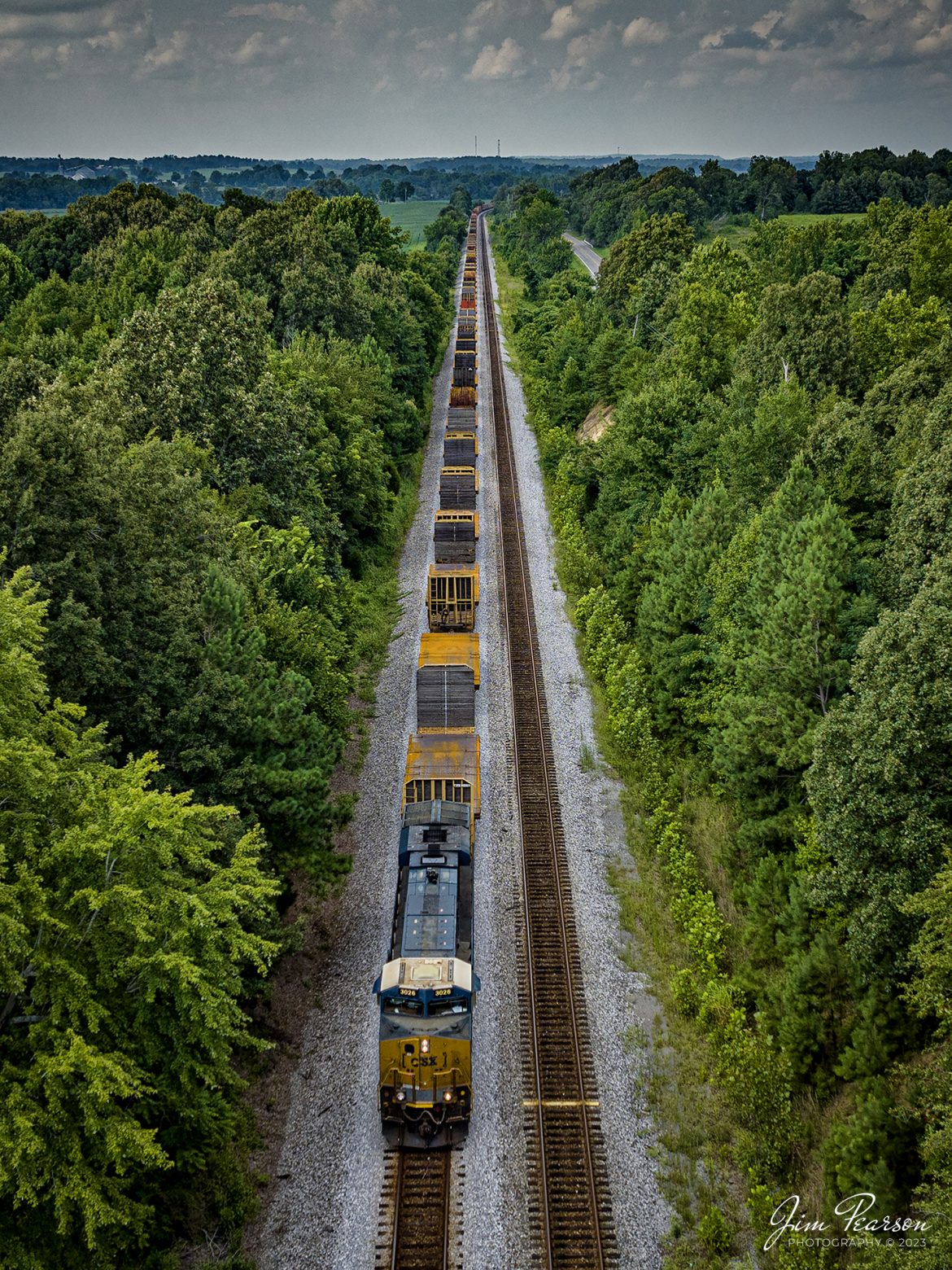 CSXT 3026 leads S980-07, a high/wide move of sheet metal, south on the CSX Henderson Subdivision on August 8th, 2023. There was a total of 99 bulkhead flat cars on the train, each loaded with 8-10 pieces of steel metal plates. I’m told they are bound for Panama City, Florida where the metal will be fabricated into industrial pipe at the Borusan Berg Pipe plant located there.

Tech Info: DJI Mavic 3 Classic Drone, RAW, 24mm, f/2.8, 1/1000, ISO 170.

#trainphotography #railroadphotography #trains #railways #dronephotography #trainphotographer #railroadphotographer #jimpearsonphotography #trains #csxt #mavic3classic #drones #trainsfromtheair #trainsfromadrone #KentuckyTrains