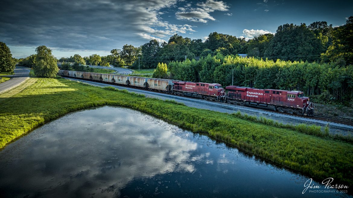 Canadian Pacific 8953 and 8831 lead empty potash train B244, as they pass the pond around the location known as poorhouse on the railroad, as it heads north on the Henderson Subdivision at Madisonville, Ky at sunset on August 15th, 2023.

This location is right around MP 279 on the Henderson Subdivision and got its name from the Louisville and Nashville Railway days when the Hopkins County Poorhouse stood near this location.

According to the Kentucky Historic Institutions website: In 1910 there were more than 84 thousand paupers that were enumerated in poorhouses in the United States; this was a marked increase of 3 percent compared to 1904. In Kentucky, the number of enumerated people in poorhouses in 1910 were 1,522; 871 being male and 651 being female. Of that population, 1,044 were native born, 167 were foreign born, 27 have unknown nativity, and 284 were colored, Irish and Swiss immigrants had a much high ratio of pauperism in 1910 than any other nationality.

According to the occupations of individuals admitted into poorhouses, unskilled laborers made up the highest number. Skilled trades also held a relatively considerable number as well. Women frequently were domestic servants prior to admission. A relatively large number of about two filths reported being unable to do any work of any kind. A statistically significant number of paupers during the year 1910 were consider physically or mentally defective though the number of insane and feeble-minded almshouses was on the decline in 1910. Three fourths of discharges were done so as self-supporting. Approximately 17,000 paupers died in poorhouses during 1910 a rate of 207.7 paupers per 1,000. The most common cause of death at that time was tuberculosis of the lungs.

In earlier days, poorhouses were sometimes used as temporary shelters for vagrants as well as a place of detention for petty criminals. This was often due to poorhouses being the only public agency available to offer relief, even to those who were insane, feeble-minded, or epileptic. Some communities combined poorhouses with free hospitals or infirmaries that catered to the poor.
Tech Info: DJI Mavic 3 Classic Drone, RAW, 24mm, f/2.8, 1/1600, ISO 390.

#trainphotography #railroadphotography #trains #railways #dronephotography #trainphotographer #railroadphotographer #jimpearsonphotography #trains #csxt #mavic3classic #drones #trainsfromtheair #trainsfromadrone #CPrailroad