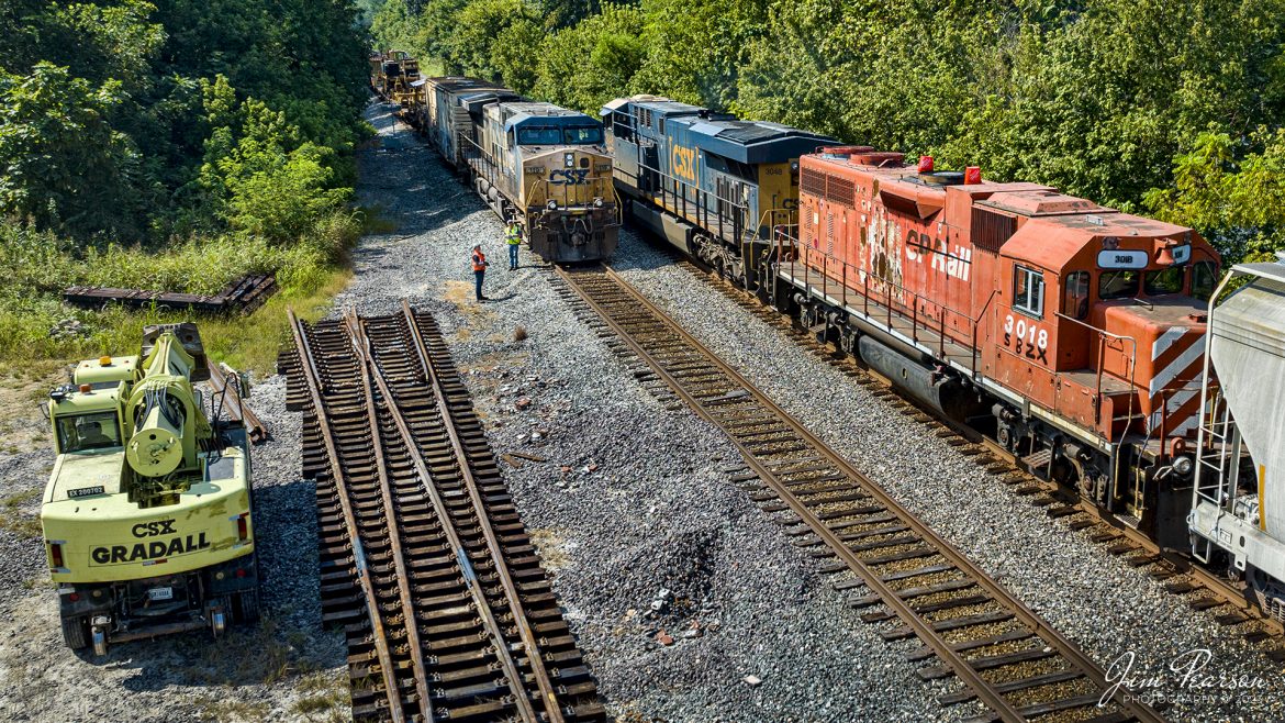The conductor and his trainee keep a watchful eye as they do a roll-by inspection of CSX southbound M513 as they pass their rail train (W016) in the siding at Hanson, Kentucky on August 25th, 2023, on the Henderson Subdivision. 

M513 had ex-CP Rail 3018 dead in tow as its trailing unit with painted new reporting marks of SBZX, and Ive not been able to find any information on the company. Anyone have any information to share?

Also sitting on the ground is a new switch that will be installed in the siding at Hanson as some point in the future.

Tech Info: DJI Mavic 3 Classic Drone, RAW, 24mm, f/2.8, 1/2000, ISO 120.

#trainphotography #railroadphotography #trains #railways #dronephotography #trainphotographer #railroadphotographer #jimpearsonphotography #trains #mavic3classic #drones #trainsfromtheair #trainsfromadrone #CPRail #Railtrain #HansonKy