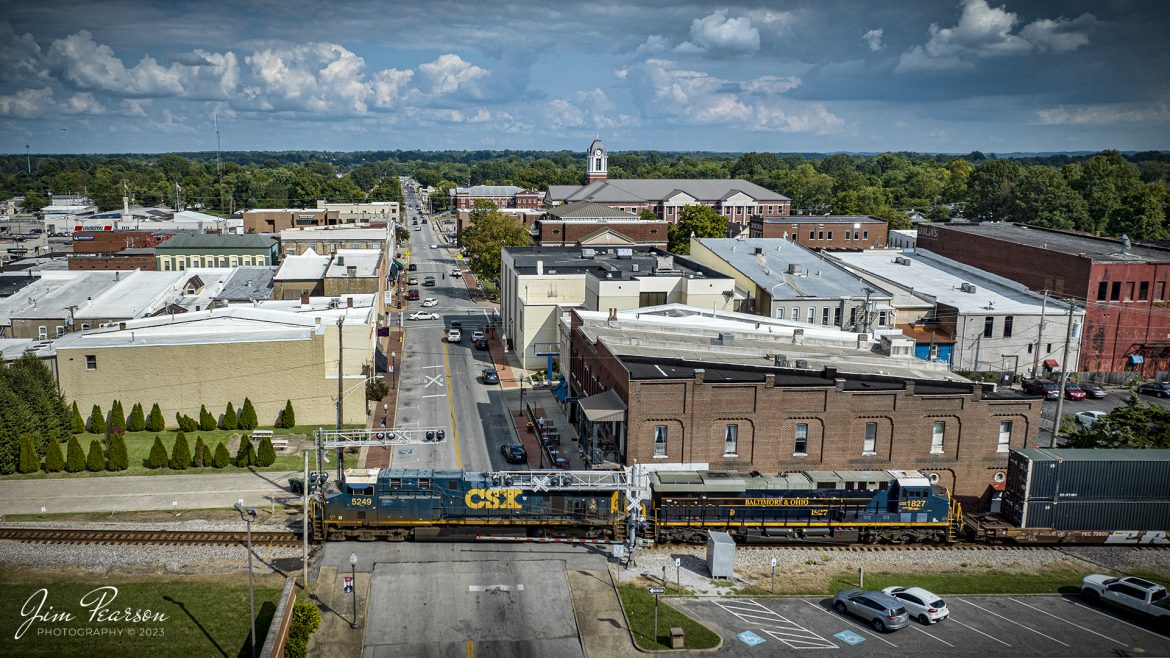 CSXT 5249 and CSX Baltimore and Ohio Heritage Unit CSXT 1827 lead CSX hot intermodal I026 as they cross over Center Street at downtown Madisonville, Kentucky as they head north to Chicago, Illinois on September 8th, 2023.

Tech Info: DJI Mavic 3 Classic Drone, RAW, 24mm, f/2.8, 1/3200, ISO 100.

#trainphotography #railroadphotography #trains #railways #dronephotography #trainphotographer #railroadphotographer #jimpearsonphotography #trains #csxt #mavic3classic #drones #trainsfromtheair #trainsfromadrone #csxheritageunit