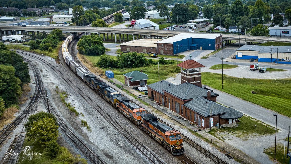 BNSF 1093 and 1005, in H1 paint scheme, lead loaded potash train CSX B207 as they pass the old L&N Depot at Henderson, Kentucky on their way north on the CSX Henderson Subdivision on September 9th, 2023.

I am told that Railmark Holdings, Inc has purchased the depot and is currently continuing restoration on the station. I have not been able to find out what their plans for the depot include yet.

According to their website: Railmark, its brands, and subsidiaries are leaders in the railroad industry in North America and around the world. An accomplished provider of railroad transportation, rail services, and rail systems development, Railmark provides a complete and fully integrated program for rail network improvement and rail management services to railroads, governments, municipalities, and industrial clients.

Railmark also owns and operates railroads in North America and sponsors philanthropic initiatives through its Railmark Foundation Limited. Together the Railmark group of rail service companies work around the world each day to make rail transportation better by improving economies and the quality of human life.


Tech Info: DJI Mavic 3 Classic Drone, RAW, 24mm, f/2.8, 1/800, ISO 120.

#trainphotography #railroadphotography #trains #railways #dronephotography #trainphotographer #railroadphotographer #jimpearsonphotography #trains #csxt #mavic3classic #drones #trainsfromtheair #trainsfromadrone