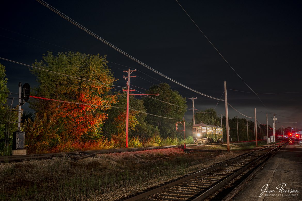 The color from the red signal gives the look of fall color as Illinois Terminal interurban coach 101 sits on the main next to the depot at the Illinois Railway Museum (IRM) in the dark on September 16th, 2023. It waits for a green signal to proceed at Union Illinois, during the IRM 70th Anniversary celebration where the museum ran trains continuously from 11am Saturday morning to 5pm Sunday afternoon, which gave a rare opportunity to photograph much of their equipment during nighttime hours.

According to the IRM website: Illinois Terminal 101 is a rare example of a center-entrance interurban coach. It operated its entire service life between St. Louis, Missouri and Alton, Illinois. These cars were built for high-speed operation and were known as “Yellowhammers” and “Alton High-speeds.” The car has been restored to its appearance in the mid-1950s.

Tech Info: Nikon D800, RAW, Nikon 10-24 @24mm, f/4.5, 30 Seconds, ISO 100.

#trainphotography #railroadphotography #trains #railways #dronephotography #trainphotographer #railroadphotographer #jimpearsonphotography #UPtrains #NikonD800 #IllinoisRailwayMuseum #trainsinbadweather #illinoistrains #interurbancoach #streetcars #trainsatnight