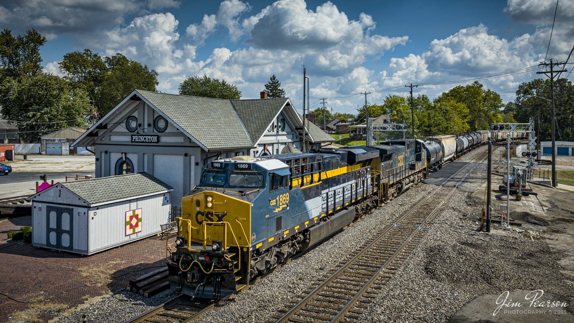 CSX Chesapeake & Ohio Heritage unit 1869 leads CSX M500 as it passes the old depot (once housing the C&EI and L&N railways) in downtown Princeton, Indiana on September 28th, 2023, as it heads north on the CE&D Subdivision. 

According to the CSX Website: A locomotive commemorating the proud history of the Chesapeake and Ohio Railway has entered service as the fifth in the CSX heritage series celebrating the lines that came together to form the modern railroad.
 
Numbered CSX 1869 in honor of the year the C&O was formed in Virginia from several smaller railroads, the newest heritage locomotive sports a custom paint design that includes todays CSX colors on the front of the engine and transitions to a paint scheme inspired by 1960s era C&O locomotives on the rear two-thirds.

The C&O Railway was a major line among North American freight and passenger railroads for nearly a century before becoming part of the Chessie System in 1972 and eventually merging into the modern CSX. In 1970, the C&O included more than 5,000 route miles of track stretching from Newport News, Virginia, to Chicago and the Great Lakes. 
 
Designed and painted at CSXs locomotive shop in Waycross, Georgia, the C&O unit will join four other commemorative units in revenue service on CSXs 20,000-mile rail network. 
 
The heritage series is reinforcing employee pride in the history of the railroad that continues to move the nations economy with safe, reliable, and sustainable rail-based transportation services.

Tech Info: DJI Mavic 3 Classic Drone, RAW, 22mm, f/2.8, 1/2000, ISO 110.

#trainphotography #railroadphotography #trains #railways #jimpearsonphotography #trainphotographer #railroadphotographer #CSXHeritageUnit #HaubstadtIN #C&OCommemorativeLocomotive