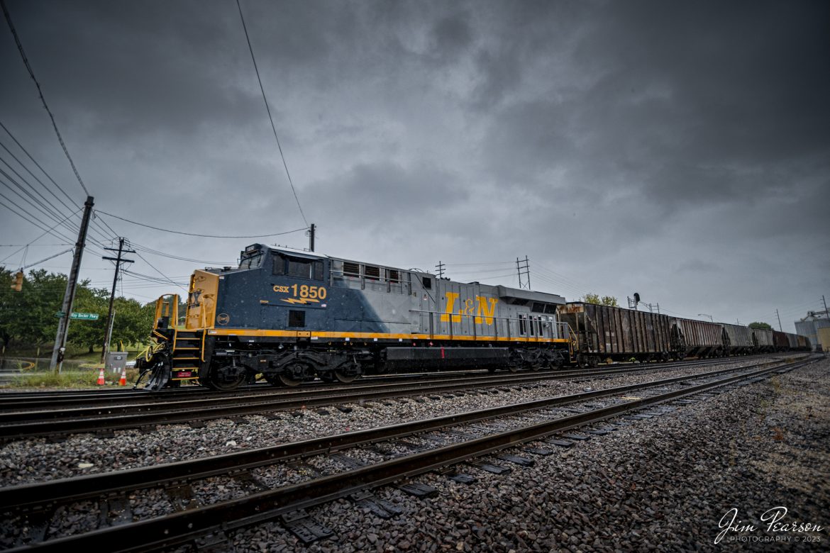 CSX Louisville and Nashville Heritage Unit 1850 leads loaded grain train G031, as it approaches CSX Howell Yard, under stormy skies, at Evansville, Indiana, on October 5th, 2023, on the CSX Evansville Terminal Subdivision. After a crew change and new train ID of G419, the loaded grain train continued its move south to Mobile, Alabama.


According to CSXT: CSX has introduced the sixth locomotive in its heritage series, a freshly painted unit honoring the Louisville & Nashville Railroad. Designated CSX 1850, the locomotive will be placed into service, carrying the L&N colors across the 20,000-mile CSX network.


The paint scheme was designed and applied at the CSX Locomotive Shop in Waycross, Georgia, which has produced all six units in the heritage series celebrating the lines that came together to form the modern CSX. Like the other heritage locomotives, the L&N unit combines the heritage railroads iconic logo and colors on the rear two-thirds of the engine with todays CSX colors and markings on the cab end.


Chartered by the State of Kentucky in 1850, the L&N grew into a vital transportation link between the Gulf Coast and the nations heartland. The railroad was absorbed by the Seaboard Coast Line Railroad, which subsequently became part of the Chessie System and, ultimately, todays CSX.


The CSX heritage series is reinforcing employee pride in the history of the railroad that continues to move the nations economy with safe, reliable, and sustainable rail-based transportation services.


Tech Info: DJI Mavic 3 Classic Drone, RAW, 22mm, f/8, 1/1250, ISO 250.


#trainphotography #railroadphotography #trains #railways #jimpearsonphotography #trainphotographer #railroadphotographer #CSXHeritage #EvansvolleIndiana #dronephoto #trainsfromadrone #IndianaTrains #CSXLandNHeritageunit