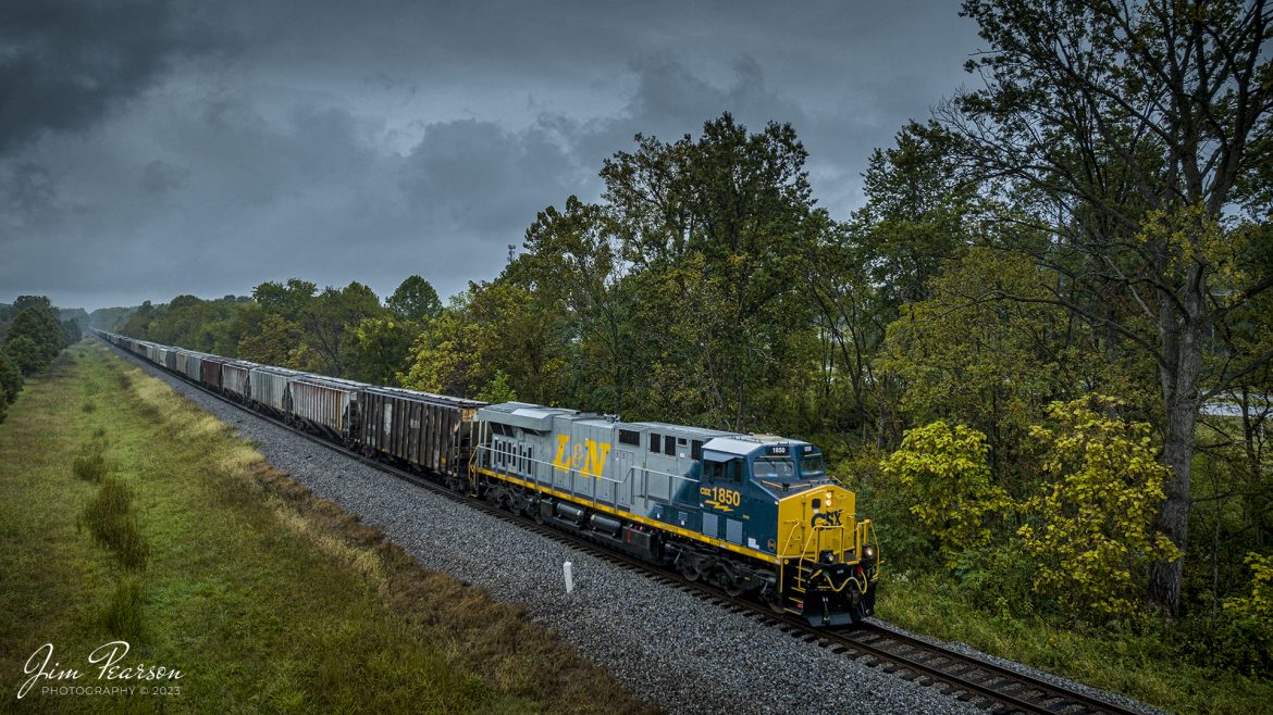 CSX Louisville and Nashville Heritage Unit 1850 leads loaded grain train G031, as it heads south under stormy skies at Darmstadt, Indiana, on October 5th, 2023, on the CE&D Subdivision, trackage that used to belong to the L&N.

According to CSXT: CSX has introduced the sixth locomotive in its heritage series, a freshly painted unit honoring the Louisville & Nashville Railroad. Designated CSX 1850, the locomotive will be placed into service, carrying the L&N colors across the 20,000-mile CSX network.

The paint scheme was designed and applied at the CSX Locomotive Shop in Waycross, Georgia, which has produced all six units in the heritage series celebrating the lines that came together to form the modern CSX. Like the other heritage locomotives, the L&N unit combines the heritage railroads iconic logo and colors on the rear two-thirds of the engine with todays CSX colors and markings on the cab end.

Chartered by the State of Kentucky in 1850, the L&N grew into a vital transportation link between the Gulf Coast and the nations heartland. The railroad was absorbed by the Seaboard Coast Line Railroad, which subsequently became part of the Chessie System and, ultimately, todays CSX.

The CSX heritage series is reinforcing employee pride in the history of the railroad that continues to move the nation's economy with safe, reliable, and sustainable rail-based transportation services.

Tech Info: DJI Mavic 3 Classic Drone, RAW, 22mm, f/8, 1/1250, ISO 200.

#trainphotography #railroadphotography #trains #railways #jimpearsonphotography #trainphotographer #railroadphotographer #CSXHeritage #DarmstadtIndiana #dronephoto #trainsfromadrone #IndianaTrains #CSXLandNHeritageunit